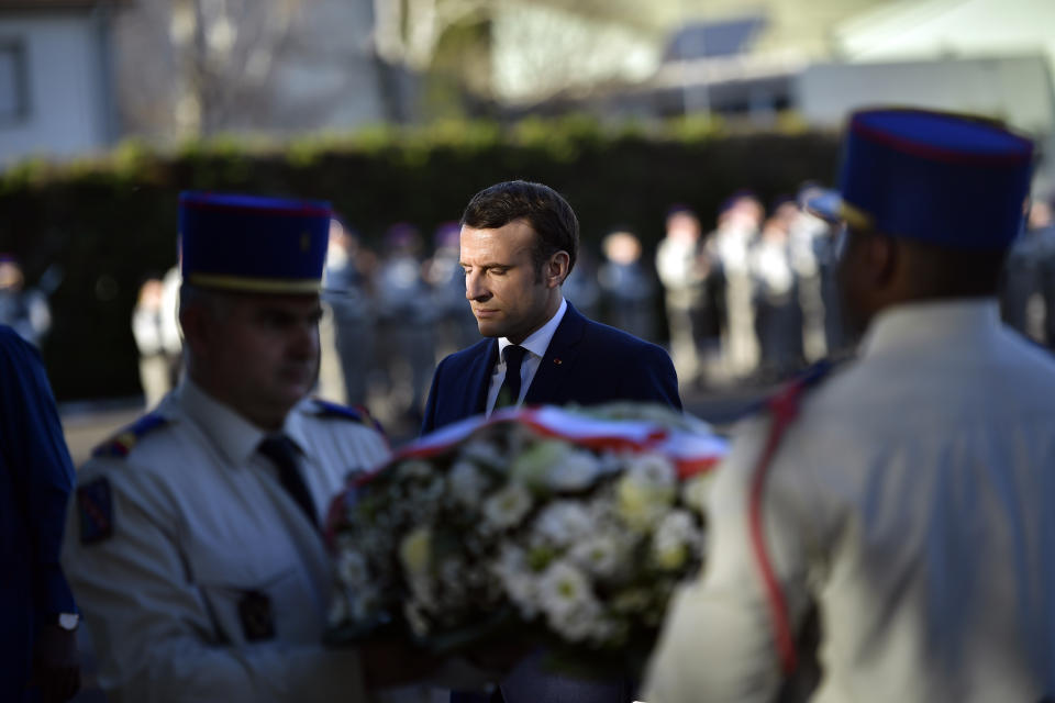 French President Emmanuel Macron lays a wreath of flowers as he pays tribute to French soldiers who died in Mali helicopter crash, Monday Jan.13, 2020 in Pau, southwestern France. France is preparing its military to better target Islamic extremists in a West African region that has seen a surge of deadly violence. (AP Photo/Alvaro Barrientos, Pool)