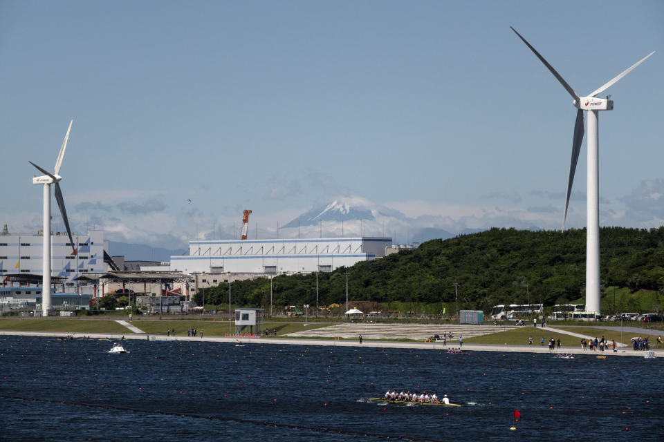 Rowers prepare for a test run at the Sea Forest Waterway, a venue for rowing at the Tokyo 2020 Olympics, as Mount Fuji is visible in the distance Sunday, June 16, 2019, in Tokyo. (AP Photo/Jae C. Hong)