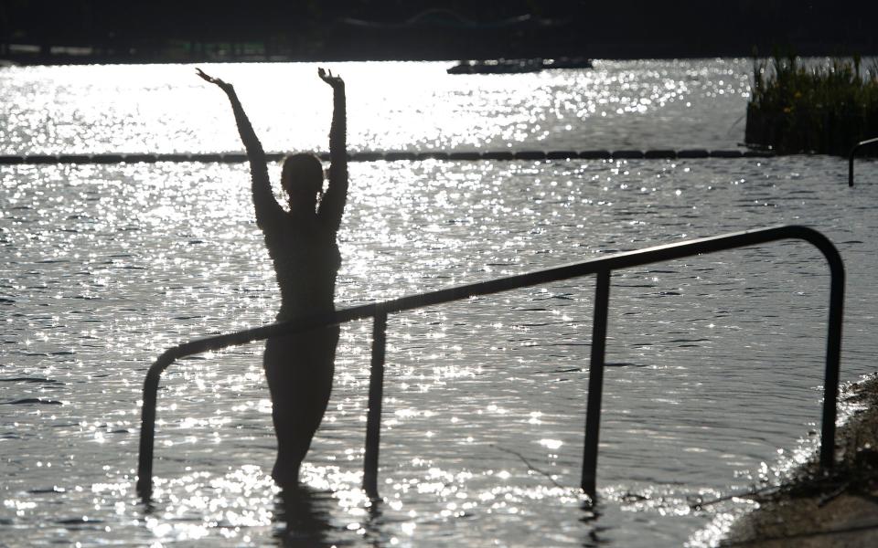 Swimmer poses in the Serpentine - EDDIE MULHOLLAND