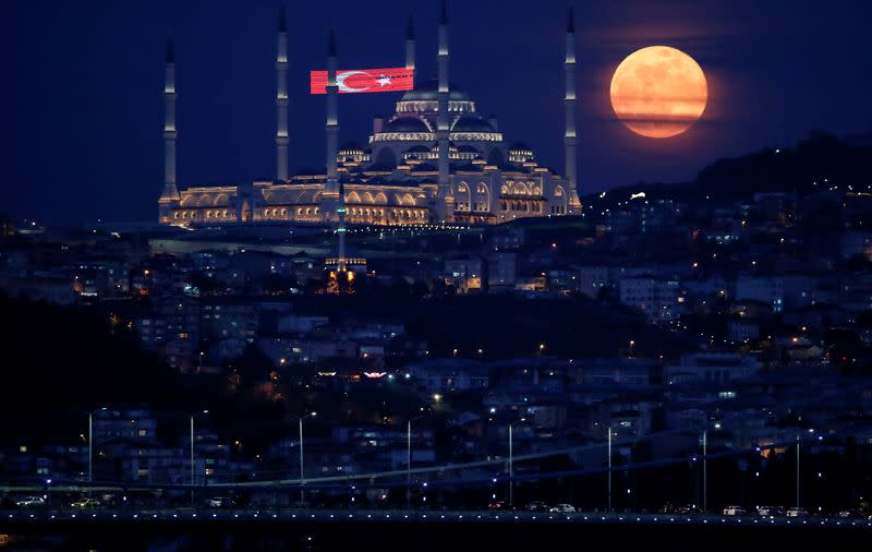 The full moon, also known as the Supermoon or Flower Moon, rises above the Camlica Mosque during the spread of the coronavirus disease (COVID-19), in Istanbul