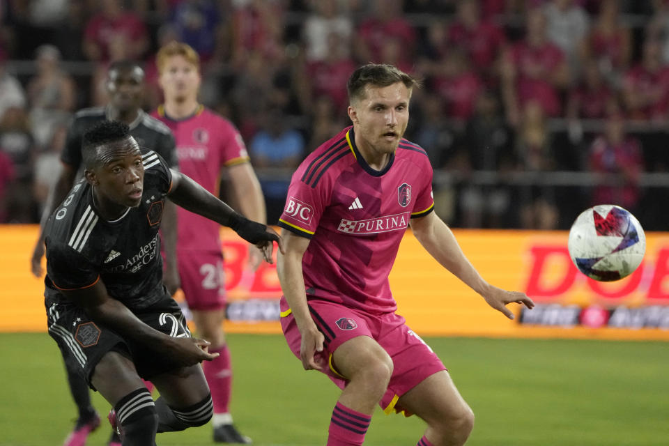 Houston Dynamo's Luis Caicedo, left, and St. Louis City's Indiana Vassilev challenge for the ball during the second half of an MLS soccer match Saturday, June 3, 2023, in St. Louis. (AP Photo/Jeff Roberson)