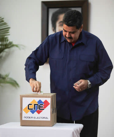 Venezuela's President Nicolas Maduro casts his vote at a polling station during a nationwide election for new mayors, in Caracas, Venezuela December 10, 2017. Miraflores Palace/Handout via REUTERS