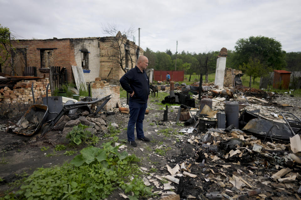 Eduard Zelenskyy stands outside his home destroyed by attacks in Potashnya, on the outskirts of Kyiv, Ukraine, Tuesday, May 31, 2022. Zelenskyy just returned to his home town after escaping war to find out he is homeless. (AP Photo/Natacha Pisarenko)