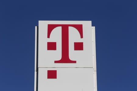 The logo of Deutsche Telekom AG stands in front of the company's headquarters in Bonn February 26, 2015. REUTERS/Wolfgang Rattay