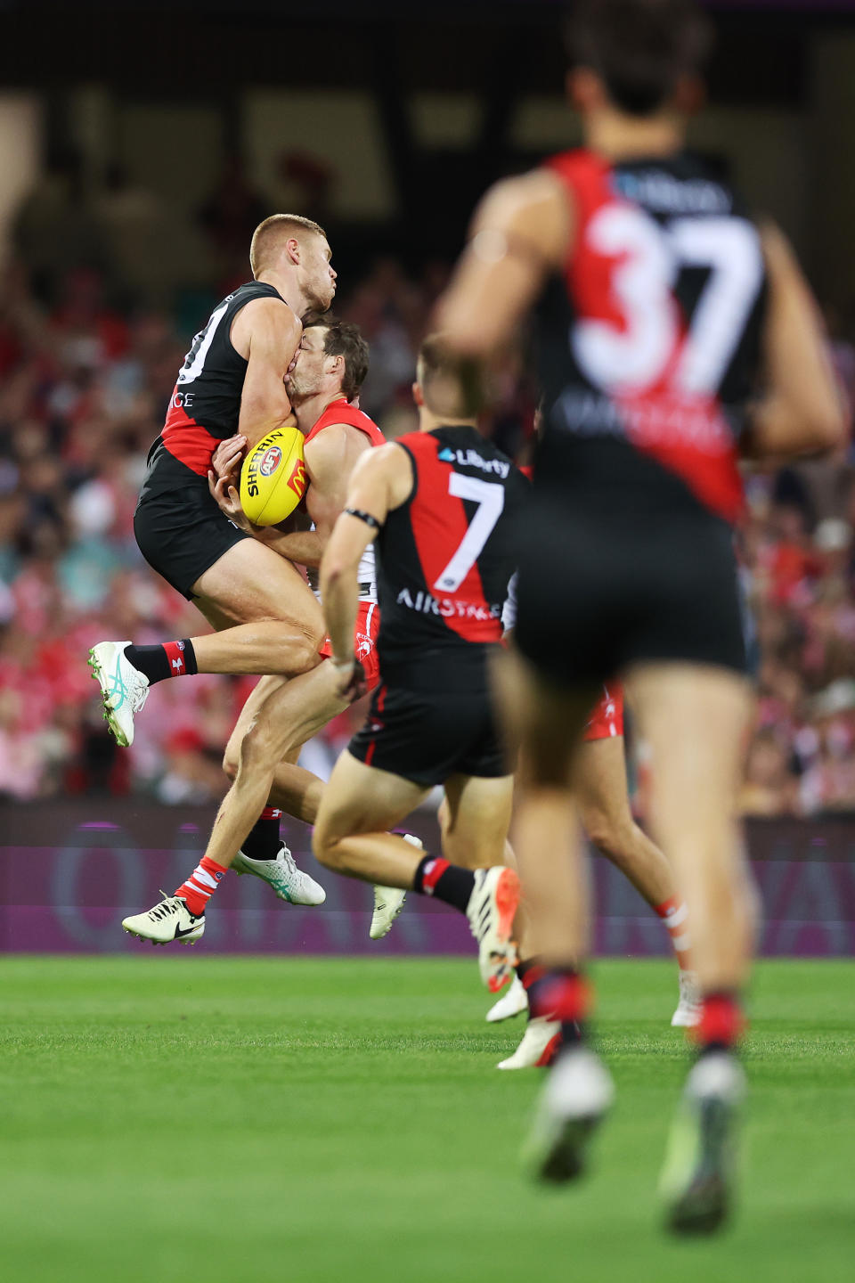 SYDNEY, AUSTRALIA - MARCH 23: Harry Cunningham of the Swans is challenged by Peter Wright of the Bombers during the round two AFL match between Sydney Swans and Essendon Bombers at SCG, on March 23, 2024, in Sydney, Australia. (Photo by Mark Metcalfe/AFL Photos/via Getty Images )