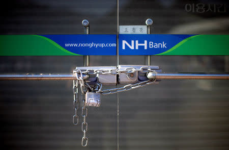 FILE PHOTO: A lock is seen on the door of a Nonghyup bank, South Korea's biggest bank, at the Mount Kumgang resort in Kumgang August 31, 2011. REUTERS/Carlos Barria/File Photo