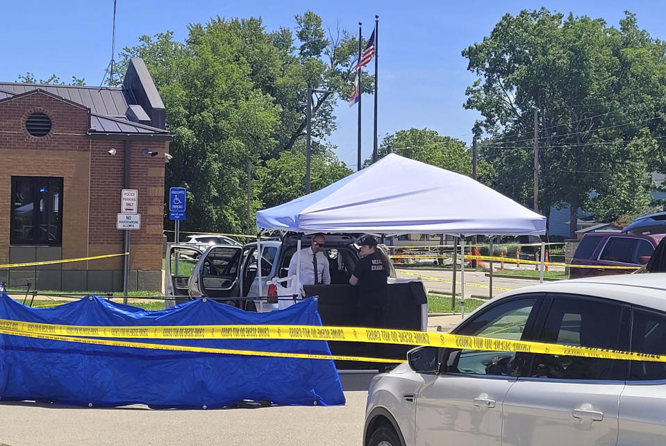 Law enforcement officers investigate a vehicle that was driven to Festus City Hall and Police Station, Tuesday morning, May 28, 2024, in Festus, Mo., by a woman who allegedly told officers she killed two of her children. (Tony Krausz/Leader Publications via AP)