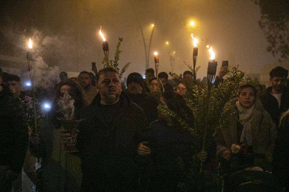 People gather in a moment of silence as they mark the one-year anniversary of the country's catastrophic earthquake, in the city of Antakya, southern Turkey, Tuesday, Feb. 6, 2024. (AP Photo/Metin Yoksu)