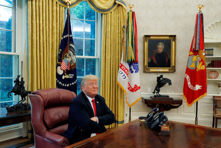 U.S. President Donald Trump smiles as he answers questions during an interview with Reuters in the Oval Office of the White House in Washington, U.S. August 20, 2018. REUTERS/Leah Millis