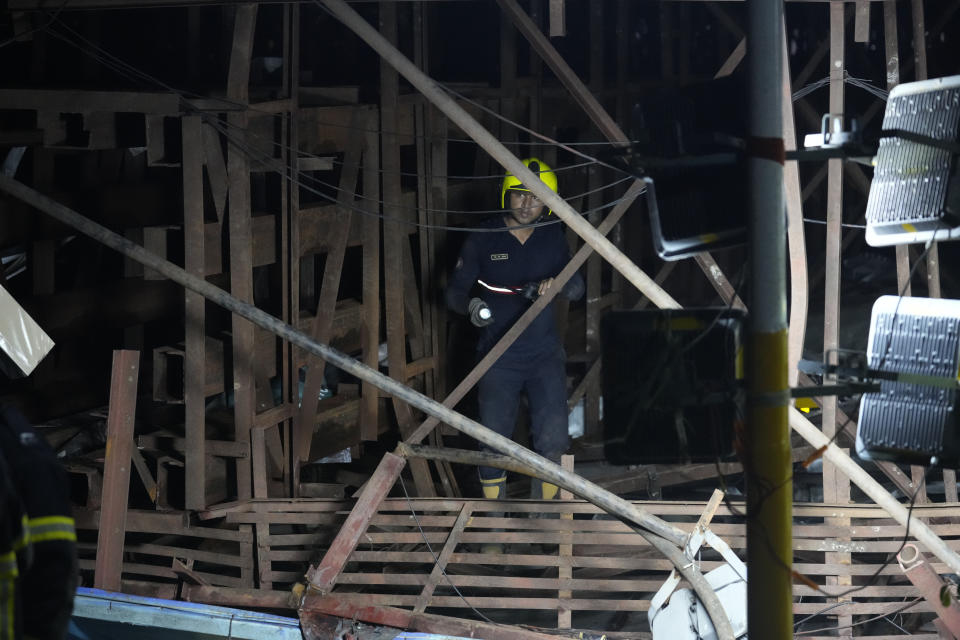 Rescuers look for victims under a billboard that collapsed following heavy rain and thundershowers in Mumbai, India, Monday, May 13, 2024. Scores of people were thought to be trapped after the collapse in the suburb of Ghatkopar, Mumbai police said on social media platform X. (AP Photo/Rafiq Maqbool)