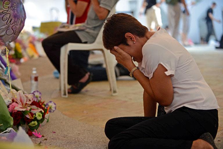 A woman mourns in the tribute area at Singapore General Hospital following Lee Kuan Yew's death