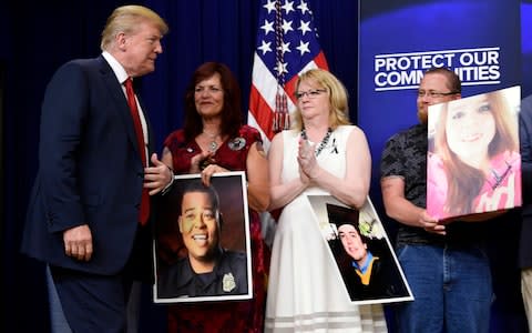 On Friday, Mr Trump hosted families of people killed by undocumented immigrants as he sought to regain the political initiative - Credit: Susan Walsh/AP