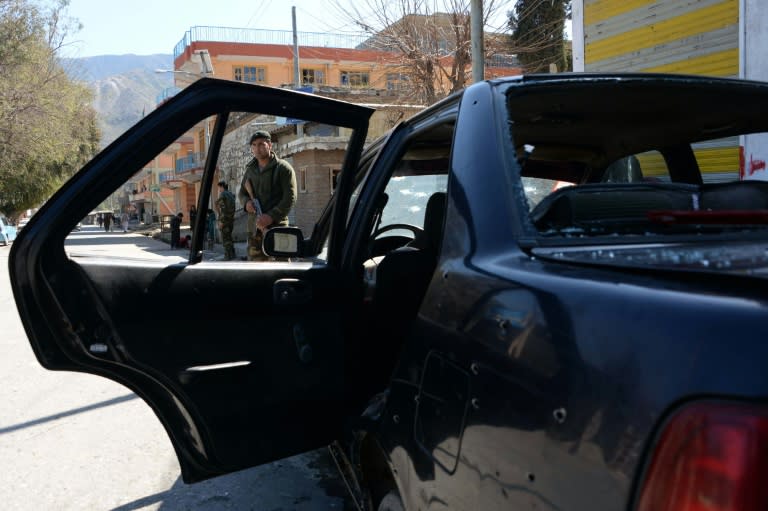 A damaged car at the site of a suicide attack in Kunar province on February 27, 2016