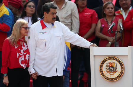 Venezuela's President Nicolas Maduro looks on next to his wife Cilia Flores during a rally in support of the government in Caracas, Venezuela May 20, 2019. REUTERS/Ivan Alvarado