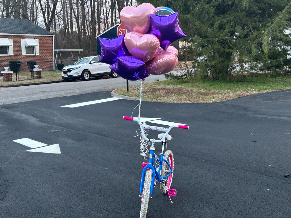 A bicycle with birthday balloons tied to it was one of the centerpieces of a candlelight vigil for P'aris Moore Tuesday, Jan. 3, 2023 in Hopewell. Tuesday would have been P'aris' ninth birthday.