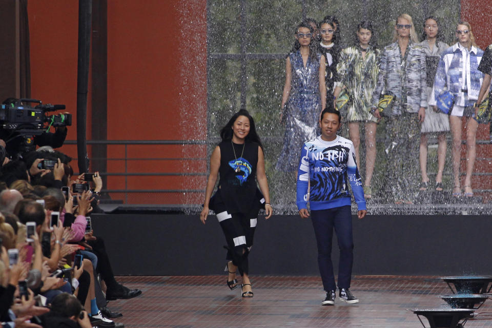 Fashion designers Humberto Leon, right, from Peru, and Carol Lim, from South Korea, acknowledge applause at the end of Kenzo's ready-to-wear Spring/Summer 2014 fashion collection, presented Sunday, Sept. 29, 2013 in Paris. (AP Photo/Thibault Camus)