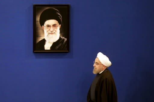 Iranian President Hassan Rouhani gives a January 17, 2017 press conference under the watchful gaze of a portrait of supreme leader Ayatollah Ali Khamenei marking the first anniversary of implementation of a historic nuclear deal with major powers
