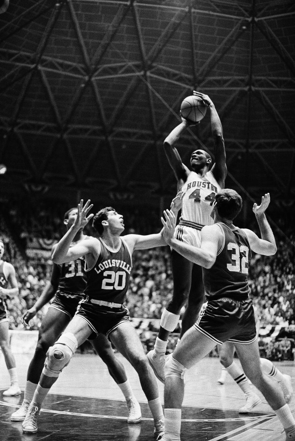 FILE - Houston's Elvin Hayes (44) gets up to pop one in for a score against Louisville in their NCAA regional tournament game in Wichita, Kan., March 15, 1968. Louisville players are: Mike Grosso, (20) and Jerry King (32). (AP Photo/File)