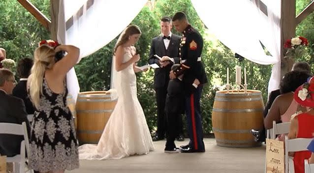 US Marine Corp Sergeant Joshua Newville embraces his son. Photo: Supplied