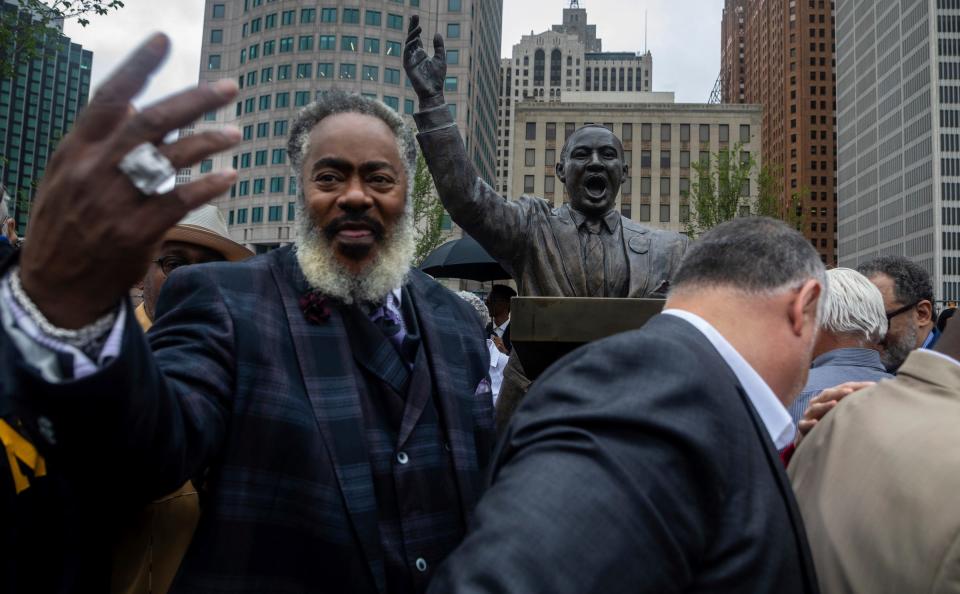 Thomas Bolden stands in front of the Martin Luther King Jr. statue alongside dozens of other community members to take a picture with the MLK statue at Hart Plaza in Detroit on Friday, June 23, 2023. 