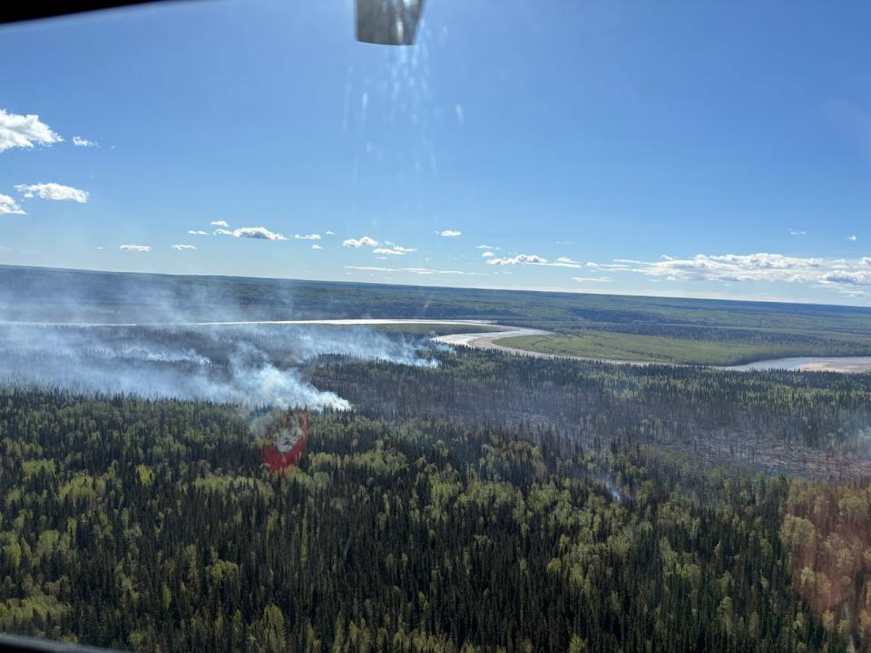 Smoke is seen from a wildfire outside Fort Liard on Monday. 