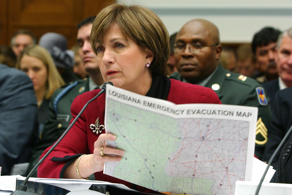 FILE- In this Dec. 14, 2005 photo, Louisiana Gov. Kathleen Blanco holds a map as she testifies on Capitol Hill, during a House Select Committee hearing on Hurricane Katrina. Blanco, who became Louisiana's first female elected governor only to see her political career derailed by the devastation of Hurricane Katrina, died Sunday, Aug. 18, 2019. She was 76. (AP Photo/Dennis Cook, File)