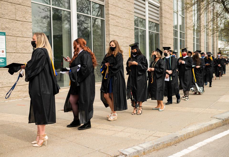 Soon-to-be graduates wait in line outside the DCU Center ahead of Becker College's final commencement ceremony in May.