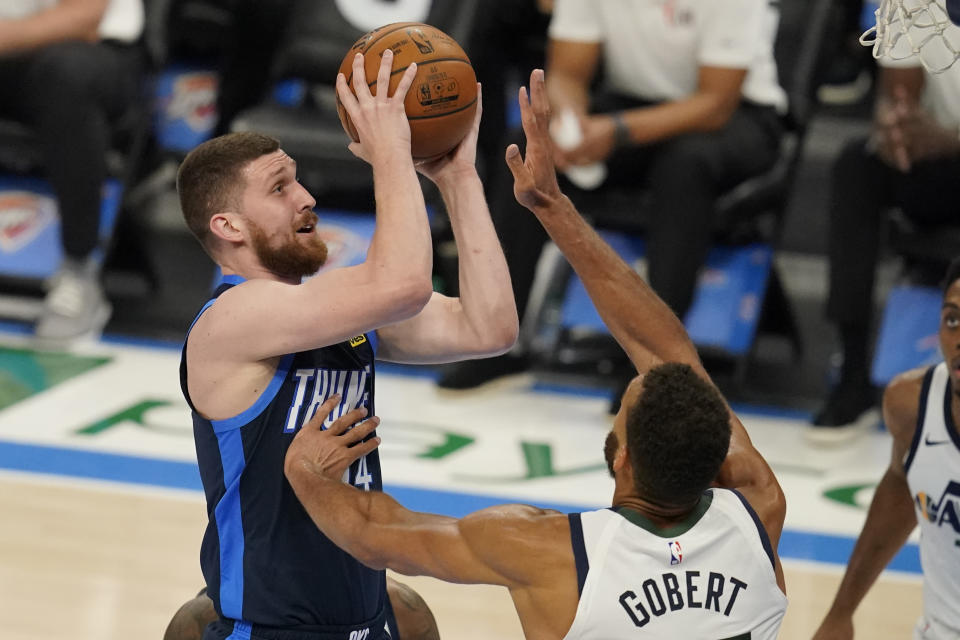 Oklahoma City Thunder guard Svi Mykhailiuk, left, goes to the basket as Utah Jazz center Rudy Gobert (27) defends in the second half of an NBA basketball game Friday, May 14, 2021, in Oklahoma City. (AP Photo/Sue Ogrocki)