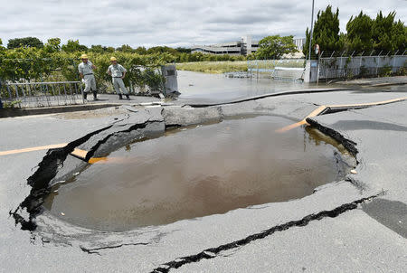 A water-filled crack on a road after water pipes were broken due to an earthquake is seen in Takatsuki, Osaka prefecture, western Japan, in this photo taken by Kyodo June 18, 2018. Mandatory credit Kyodo/via REUTERS