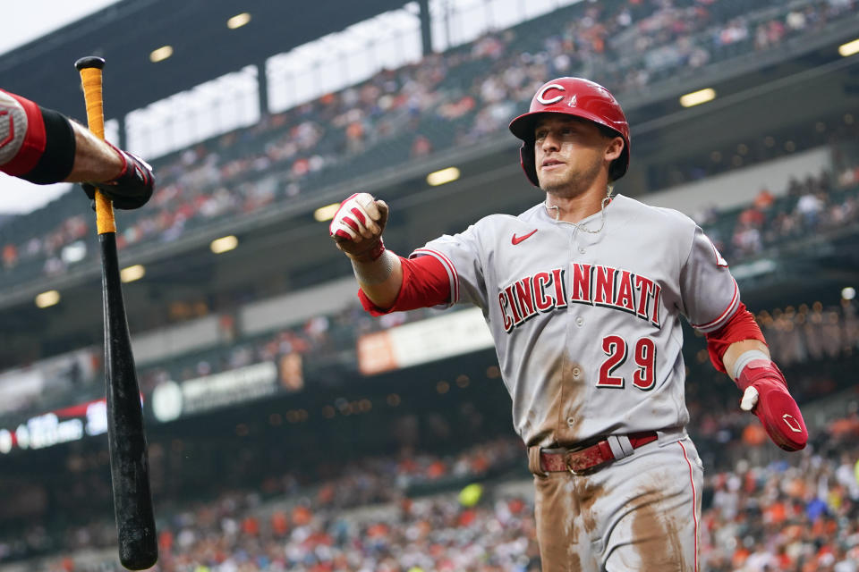 Cincinnati Reds' TJ Friedl is greeted near the dugout after scoring on a single by Elly De La Cruz in the first inning of a baseball game, Wednesday, June 28, 2023, in Baltimore. (AP Photo/Julio Cortez)