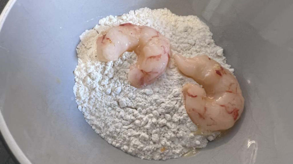 Raw shrimp in a bowl with flour