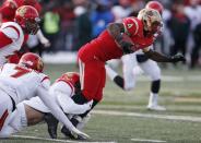 Laval Rouge et Or running back Pascal Lochard (R) drives for yardage against the Calgary Dinos during the Vanier Cup University Championship football game in Quebec City, Quebec, November 23, 2013. REUTERS/Mathieu Belanger (CANADA - Tags: SPORT FOOTBALL)