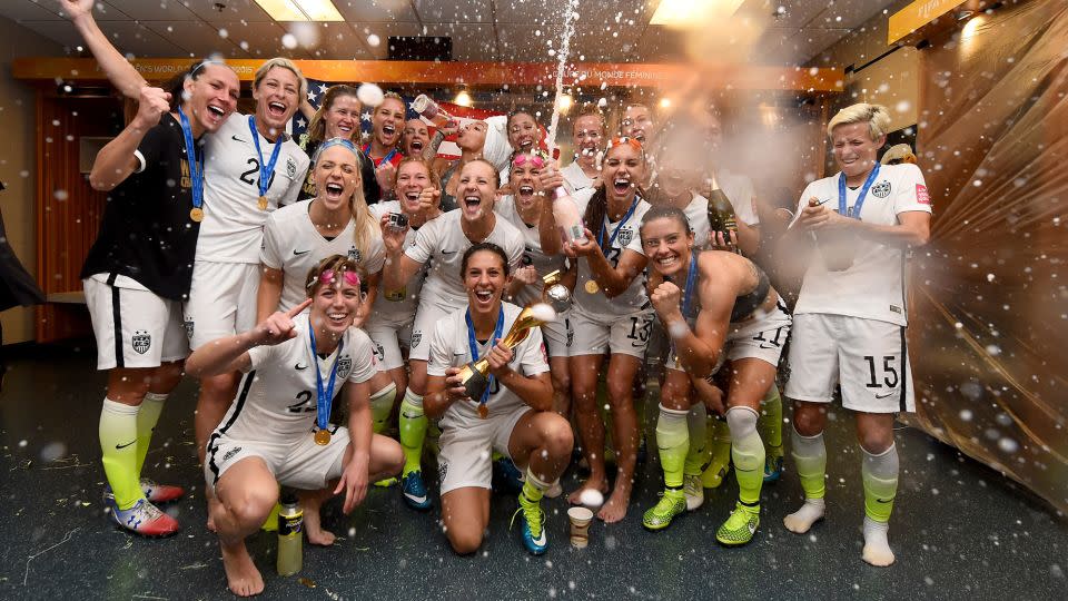 Lloyd celebrates with the trophy in the locker room after winning the World Cup. - Lars Baron/FIFA/Getty Images