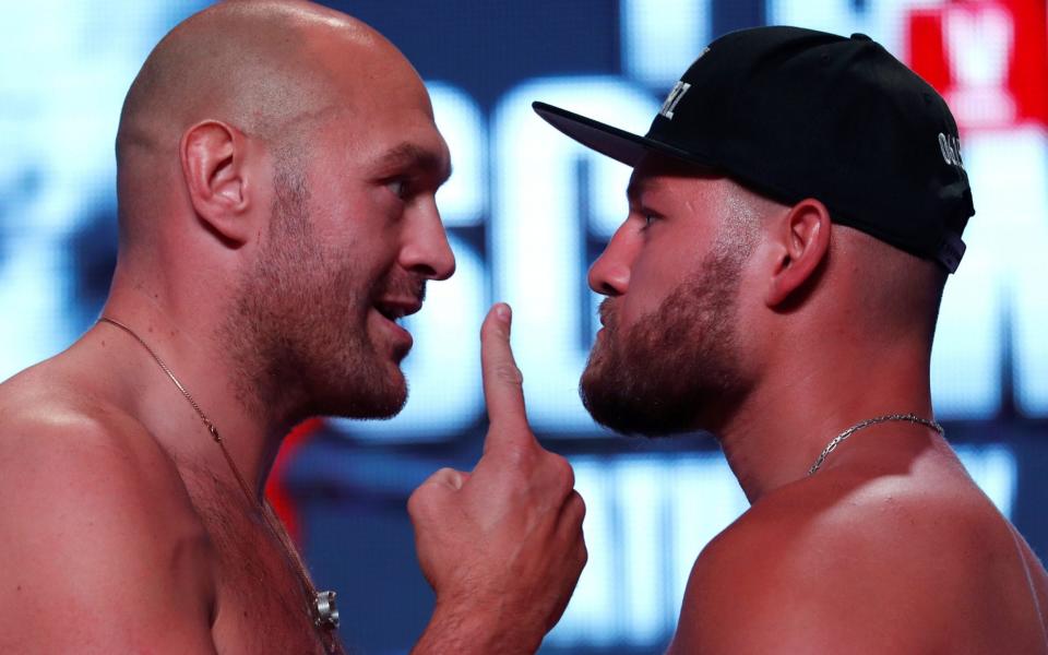 Tyson Fury (left) and Tom Schwarz (right) look into each other's eyes - REUTERS