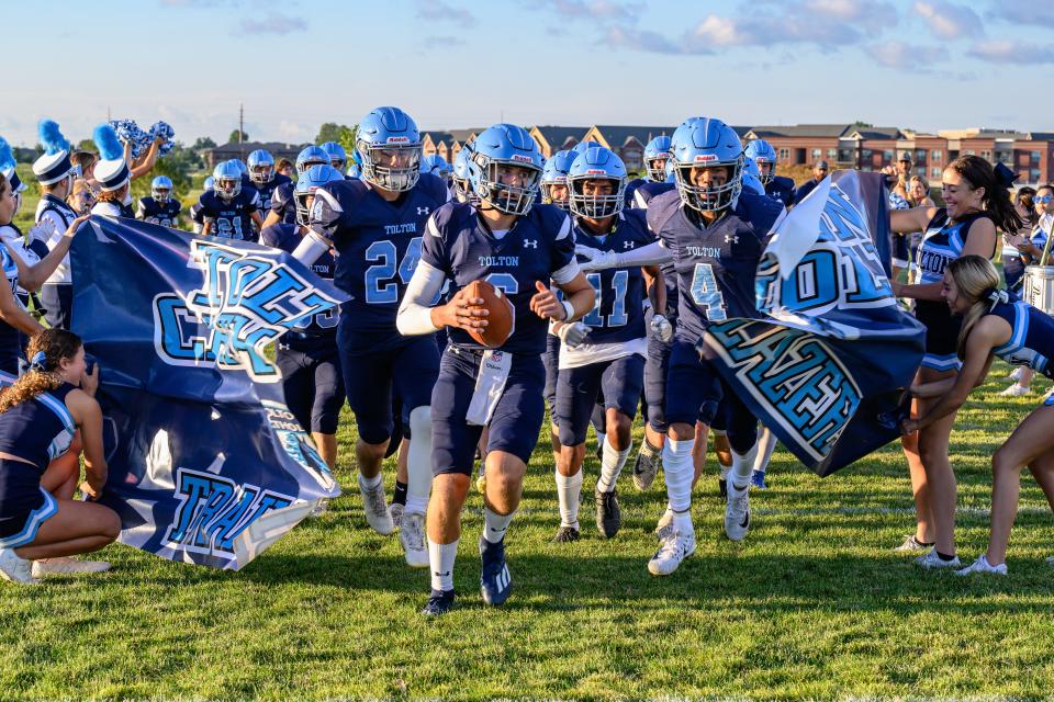Tolton's Jake Ryan (6) breaks through the banner to lead his team onto the field before the Trailblazers' game against Putnam County on Sept. 2, 2022.