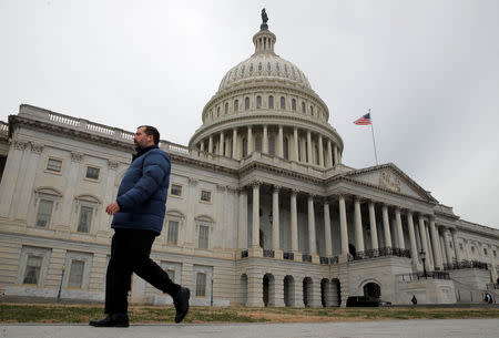 A man walks past the U.S. Capitol building as a partial government shutdown continues in Washington, U.S., January 7, 2019. REUTERS/Jim Young