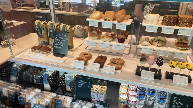 display case with sandwiches, baked goods