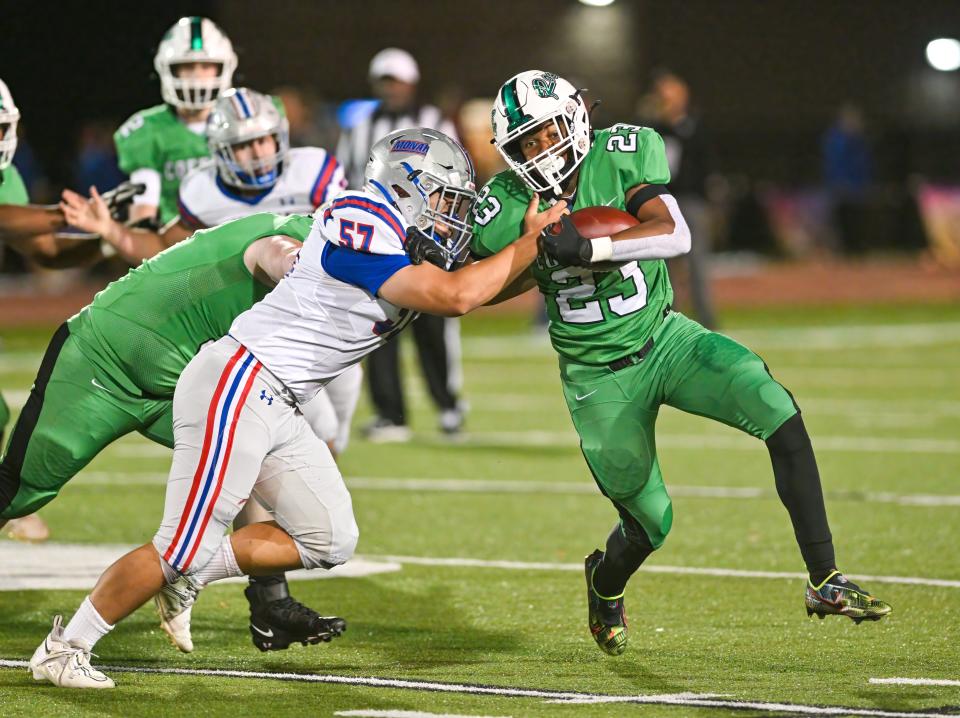 Dublin Coffman’s Daven White tries to elude Marysville’s Ethan Moeller during a Division I first-round playoff game Oct. 28.
