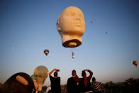 <p>People are seen watching hot air balloons fly overhead during a two-day international hot air balloon festival in Eshkol Park near the southern city of Netivot, Israel July 22, 2016. (Amir Cohen/Reuters)</p>