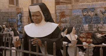 Whoopi Goldberg as a nun in "Sister Act," expressing surprise with a comical facial expression