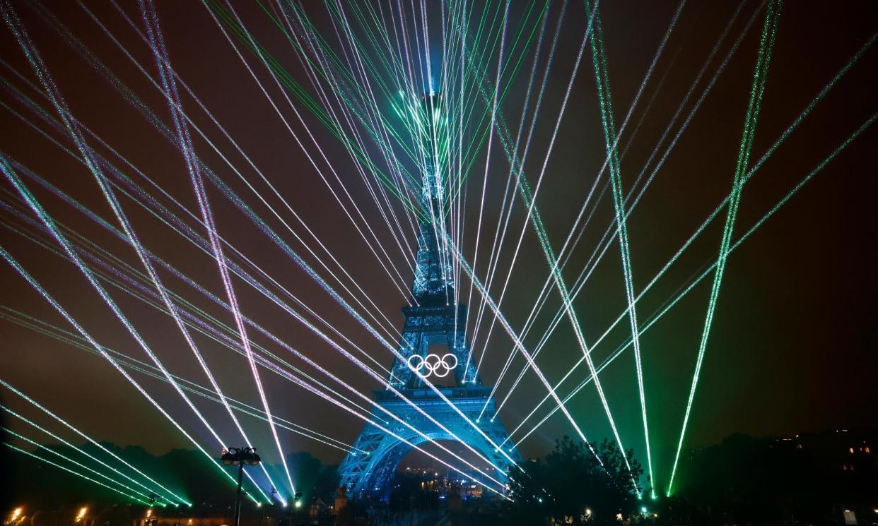 <span>Shafts of light surround the Eiffel Tower during the Paris 2024 Olympics opening ceremony.</span><span>Photograph: Tom Jenkins/The Guardian</span>