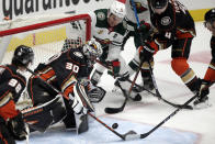 Anaheim Ducks goaltender Ryan Miller (30) eyes the puck as Minnesota Wild left wing Zach Parise (11) and Ducks defenseman Cam Fowler (4) look for a rebound during the first period of an NHL hockey game in Anaheim, Calif., Wednesday, Jan. 20, 2021. (AP Photo/Alex Gallardo)