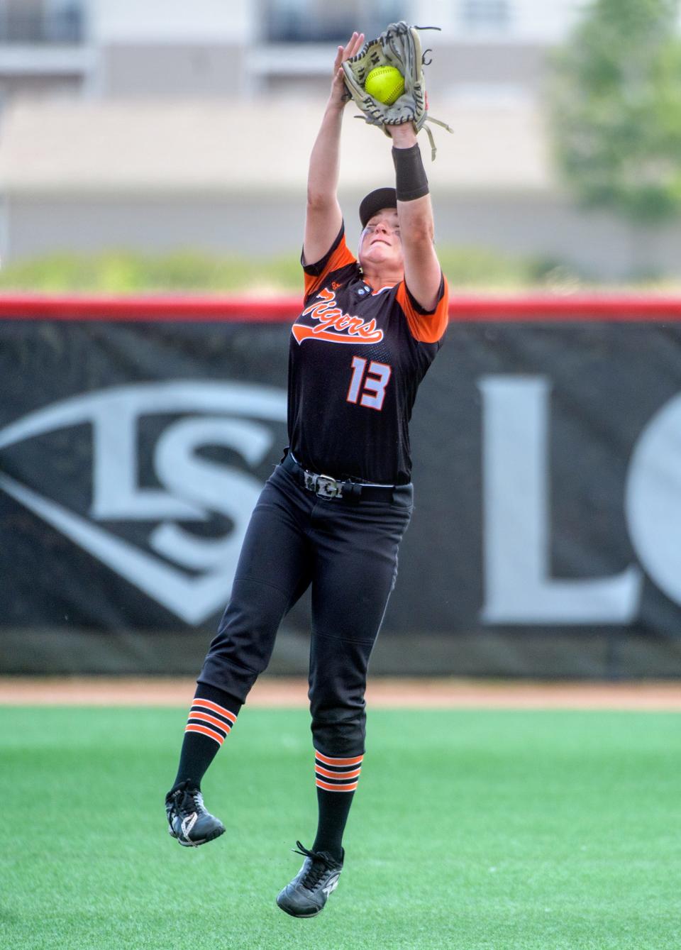 Illini Bluffs shortstop Zoe Eeten leaps to catch a high fly ball from LeRoy during the Class 1A softball state semifinals Friday, June 2, 2023 at the Louisville Slugger Sports Complex in Peoria. The Tigers advanced to the Saturday title game with a 10-0 win in five innings.