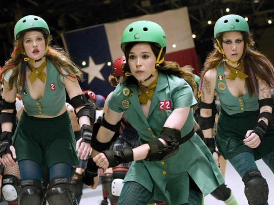 Three roller derby players wearing green outfits and helmets in the movie "Whip It."