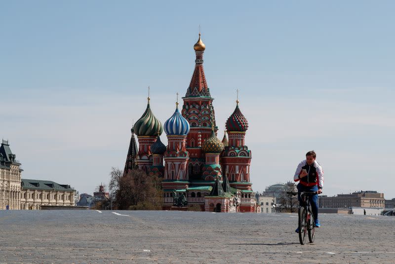FILE PHOTO: A man rides a bicycle along empty Red Square amid the coronavirus disease outbreak in Moscow