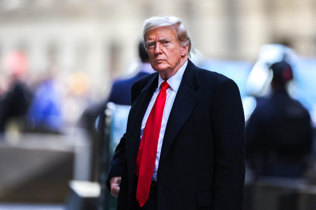 Former US President Donald Trump arrives at 40 Wall Street after his court hearing to determine the date of his trial for allegedly covering up hush money payments linked to extramarital affairs in New York City on March 25, 2024. Trump faces twin legal crises today in New York, where he could see the possible seizure of his storied properties over a massive fine as he separately fights to delay a criminal trial even further. (Photo by Charly TRIBALLEAU / AFP) (Photo by CHARLY TRIBALLEAU/AFP via Getty Images)