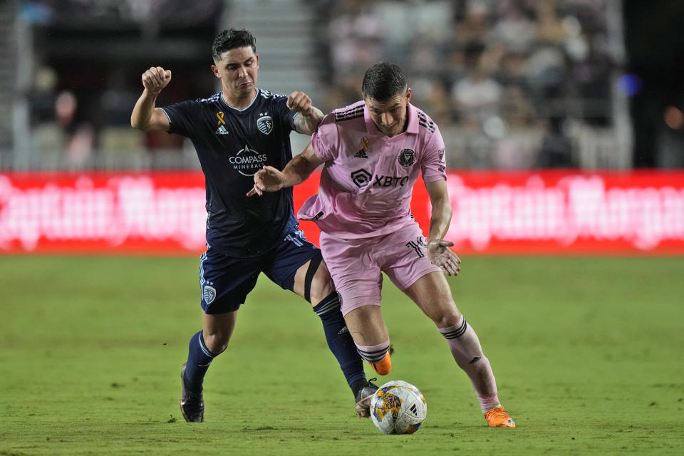 Sporting Kansas City midfielder Felipe Gutierrez, left, and Inter Miami forward Robbie Robinson battle for the ball, Saturday, Sept. 9, 2023, during the first half of an MLS soccer match in Fort Lauderdale, Fla. (AP Photo/Wilfredo Lee)