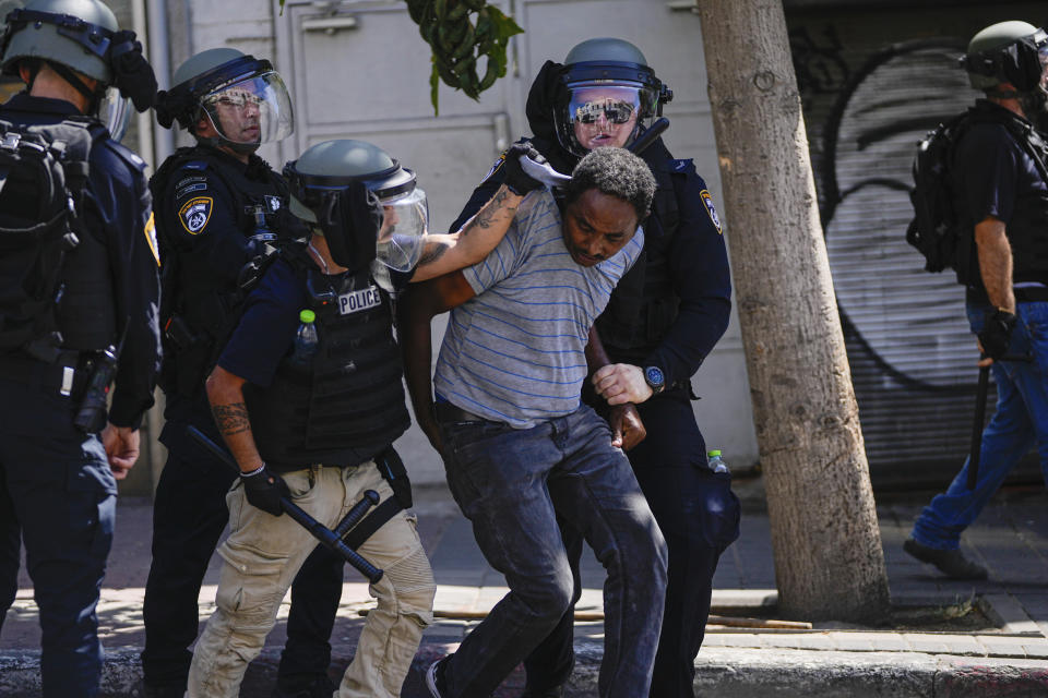 Eritrean protesters clash with Israeli riot police in Tel Aviv, Israel, Saturday, Sept. 2, 2023. Hundreds of Eritrean asylum seekers smashed shop windows and police cars in Tel Aviv on Saturday and clashed with police during a protest against an event organized by the Eritrea Embassy. The Israeli police said 27 officers were injured in the clashes, and at least three protesters were shot when police opened fire with live rounds when they felt "real danger to their lives." (AP Photo/Ohad Zwigenberg)