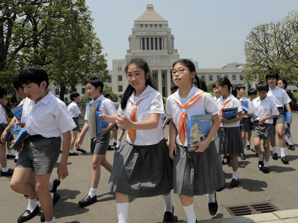 In this Tuesday, May 14 photo, junior high school students walk in the compound as they tour Parliament in Tokyo. Parliament, or the National Diet, as it is officially known, stands on a site once occupied by feudal lords and is now home to Japan's legislative headquarters. Completed in 1936, the building with a landmark pyramid-shaped dome houses the two chambers - the more powerful House of Representatives (Lower House) and the House of Councilors (Upper House) - under Japanese parliamentary system. (AP Photo/Itsuo Inouye)