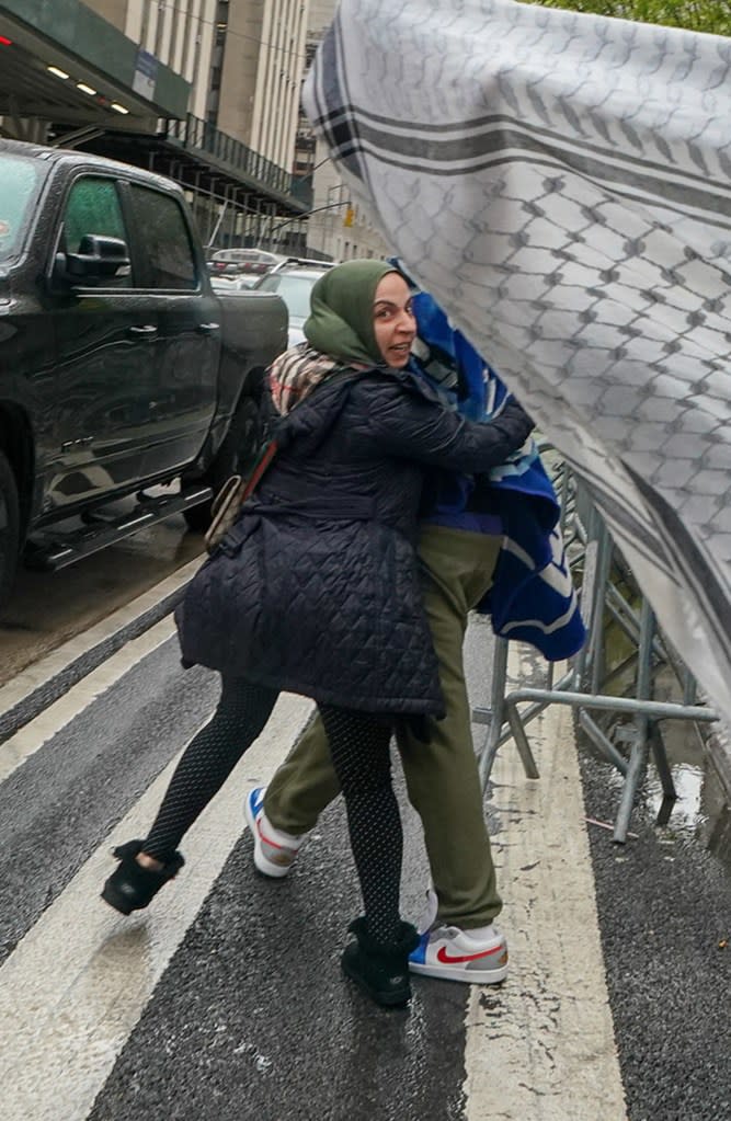 The teen’s family shields him from cameras outside court Friday. Robert Miller